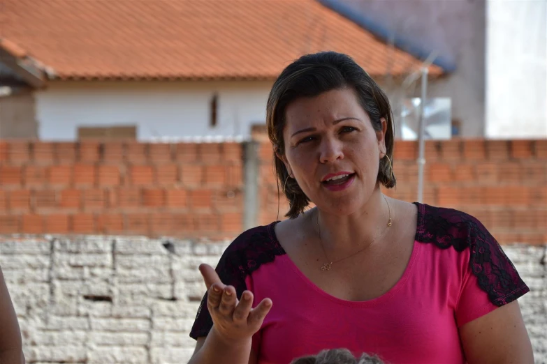 woman with microphone speaking with her hands