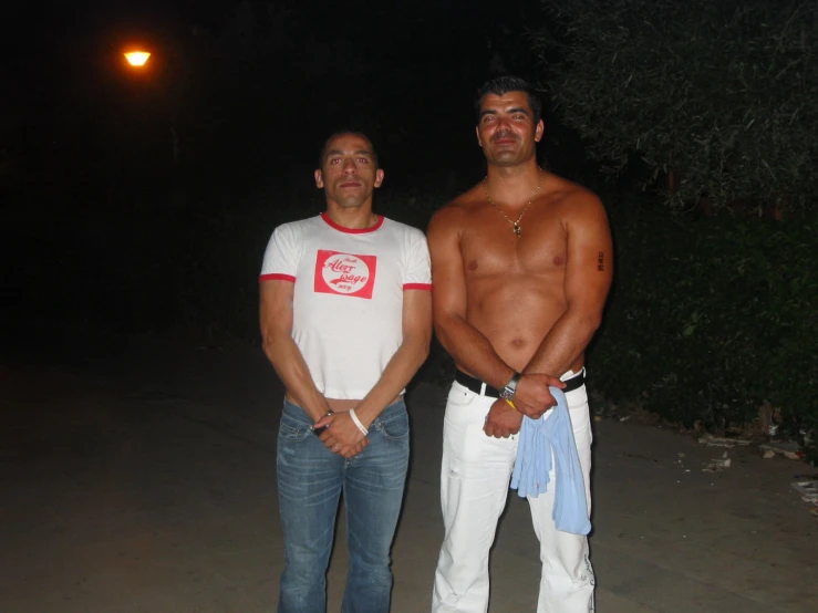 two men standing next to each other posing