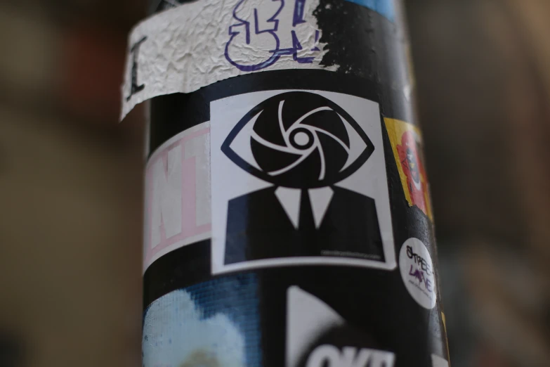 a close up of a black sticker on a pole