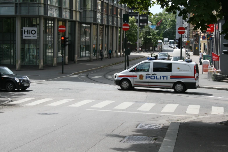 a police van is driving down a busy city street