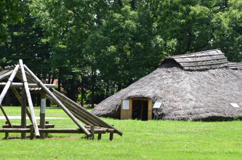 a hut with two small huts, and a wooden structure