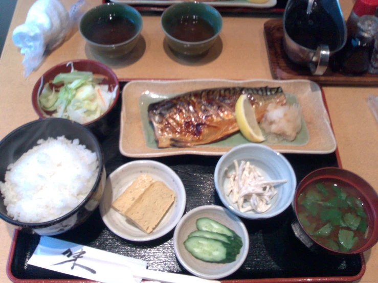 an assortment of fish on plates on a table