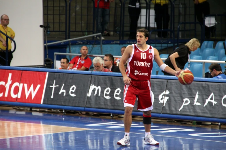 a basketball player in the middle of a game with a ball