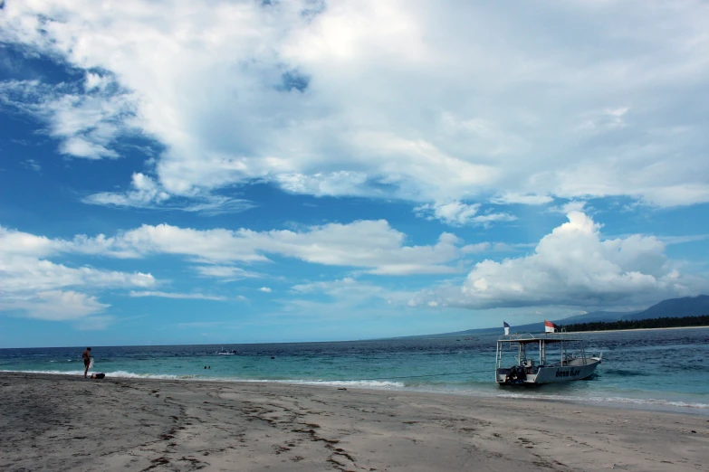 an ocean beach with a couple of boats on it