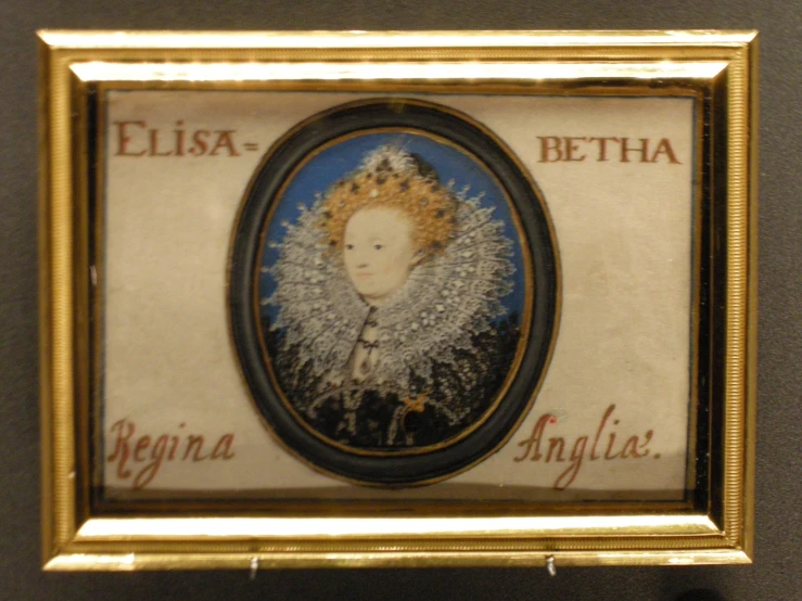an antique portrait in a golden frame hanging on a wall