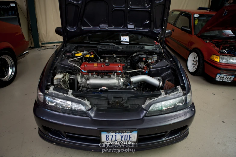 a sub on an engine in the trunk of a car