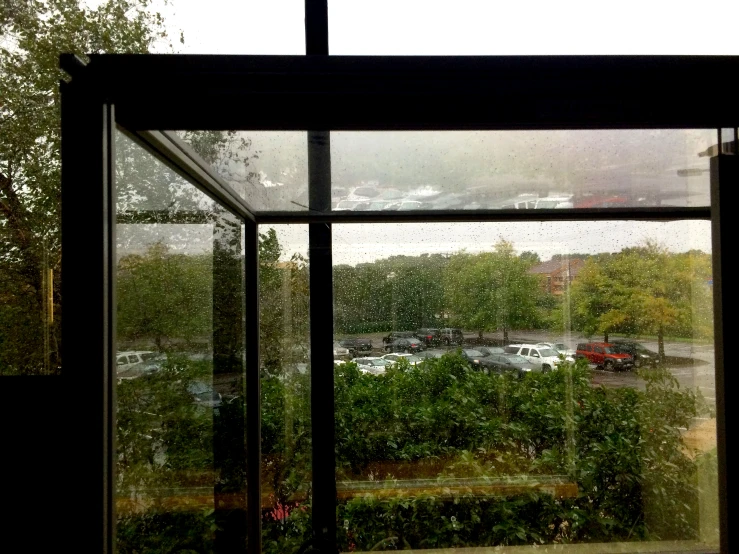 the view from inside the building into a parking lot