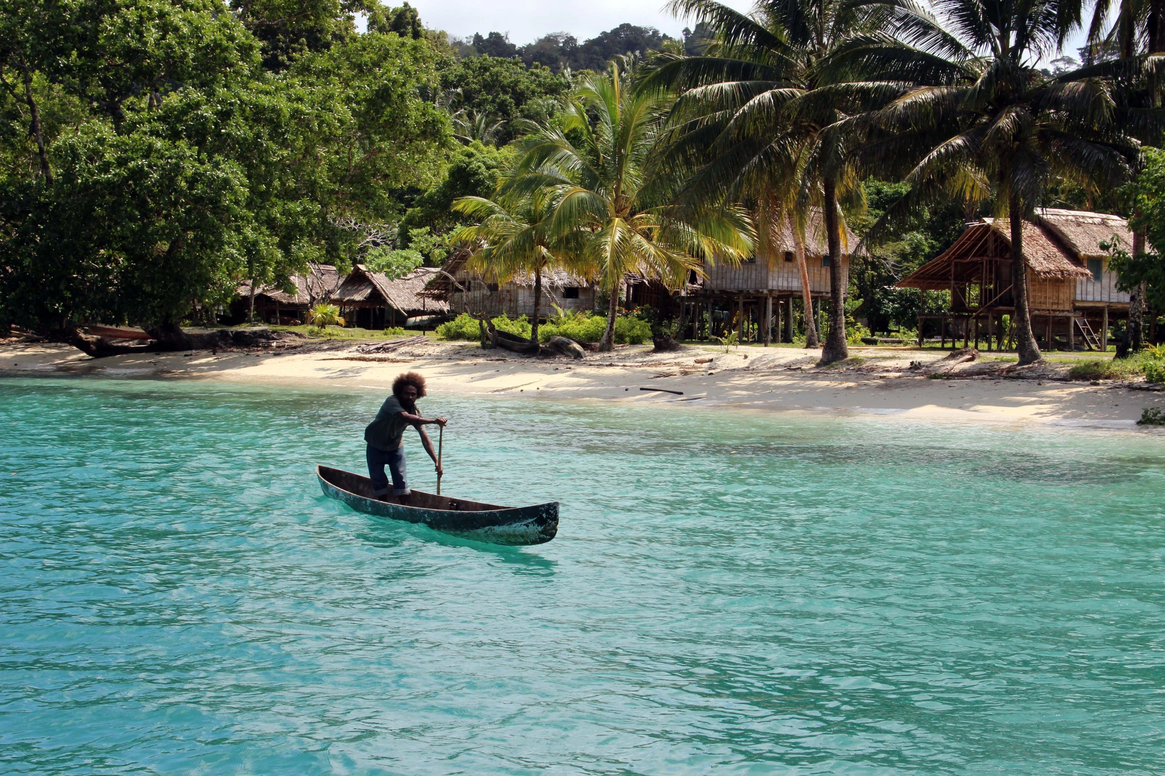 a man riding a paddle boat through the water