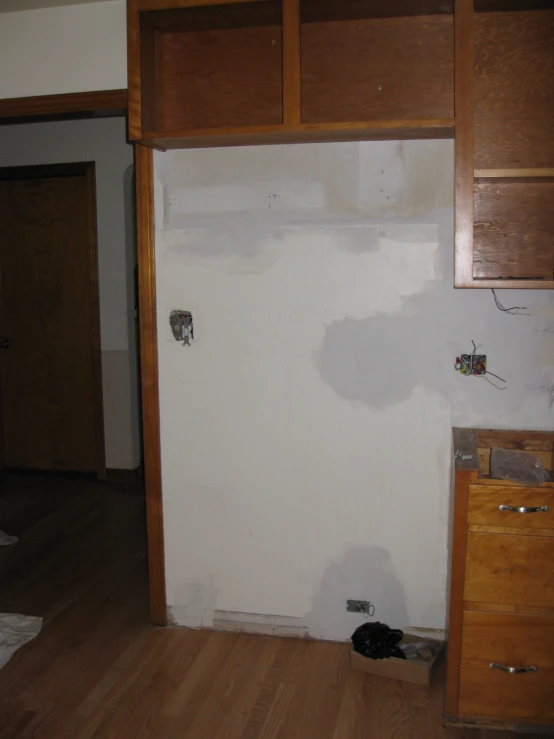 the walls of the kitchen are plastered with chipped paint