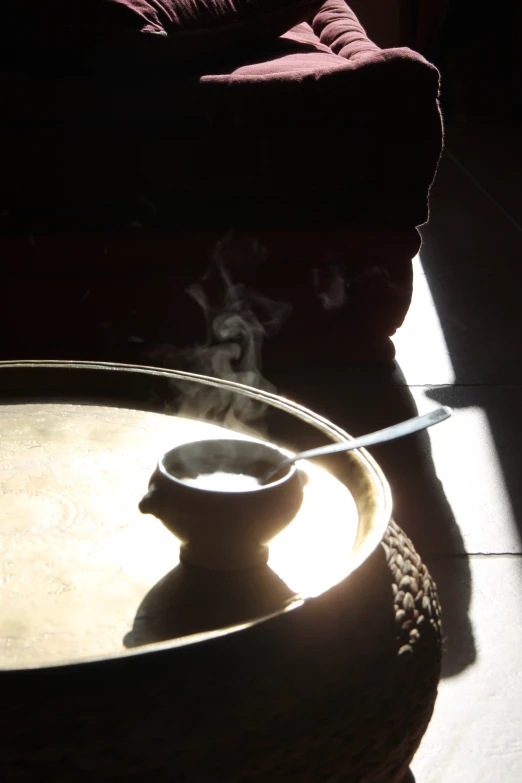 the shadow of an empty coffee pot on a table