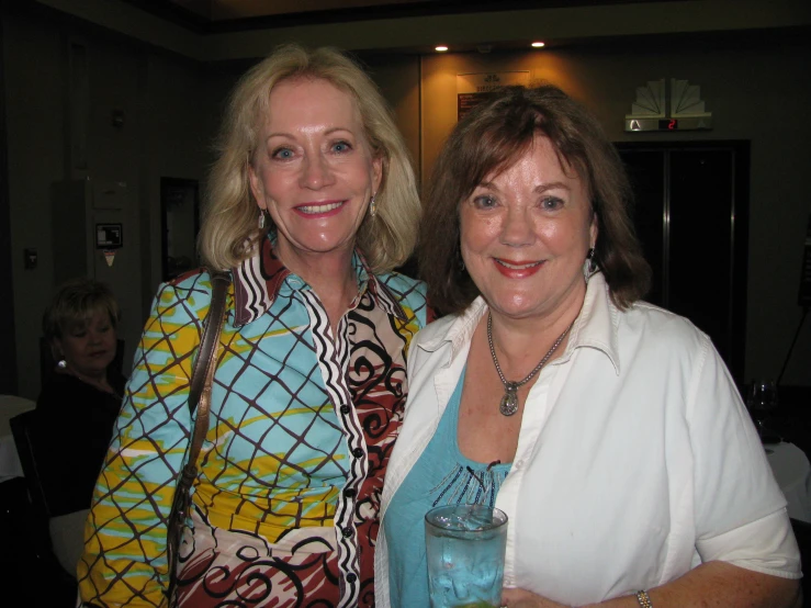 two women are posing for a po at the party