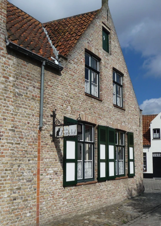 an old brick building with windows and a sky background