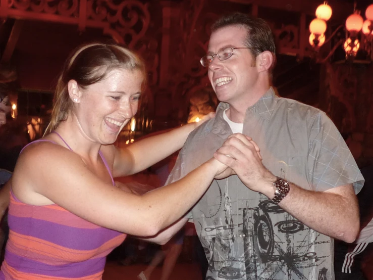 a woman is fixing a man's tie with his hand