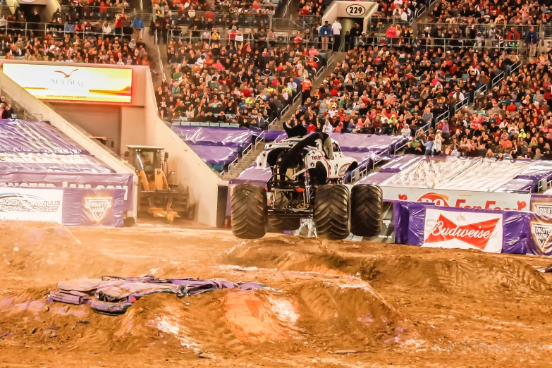 monster trucks are racing during a sporting event