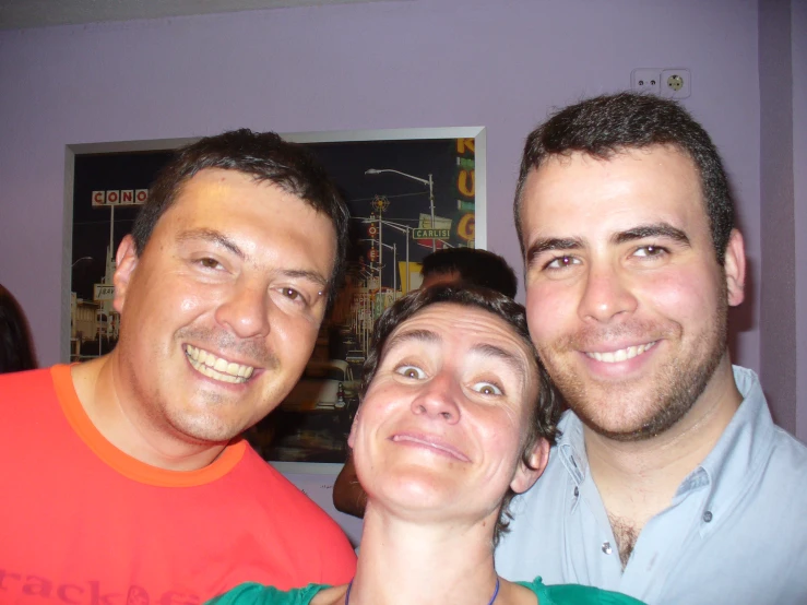 three people with their faces smiling in the camera