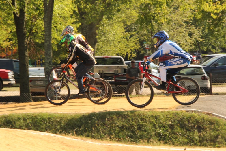 there are two men riding bicycles on a road