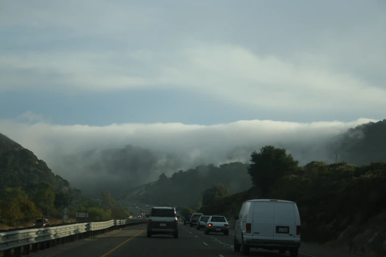 a couple of cars are driving down the road