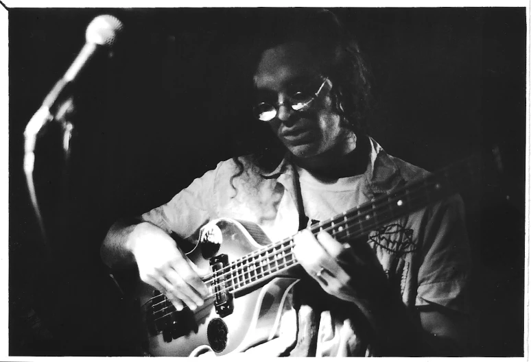 a man playing an electric guitar with one hand