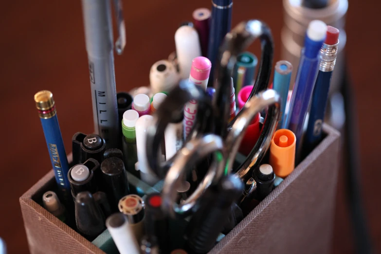 a pen and pencil holder with many office items