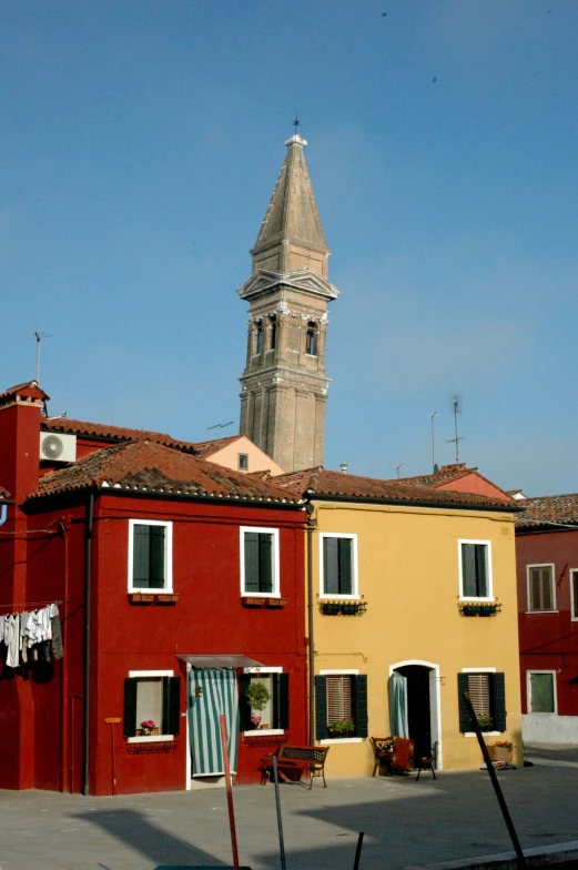 the building has a tall steeple in front of it