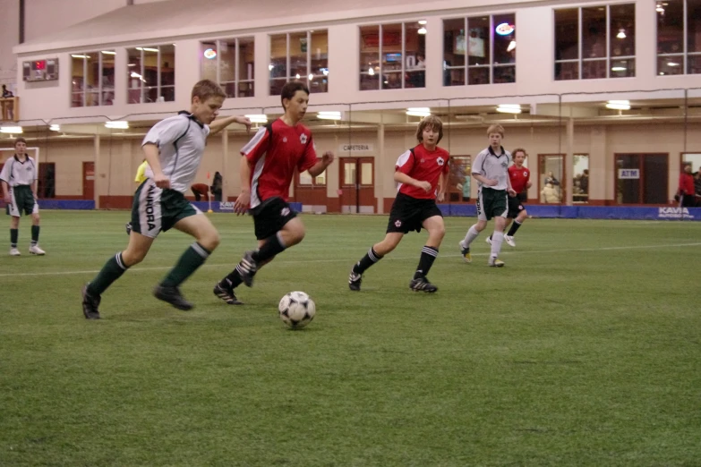 several children playing a game of soccer against each other