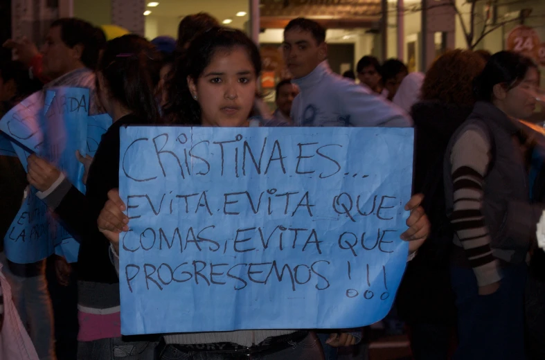 a person holding up a sign at an event