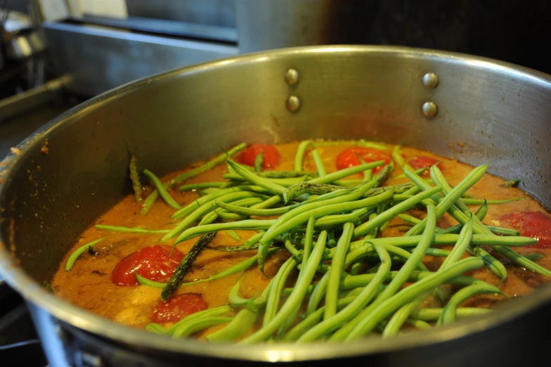 some vegetables and sauce are cooking in a pan