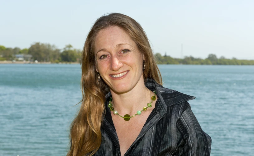 a woman in a black jacket posing for a po