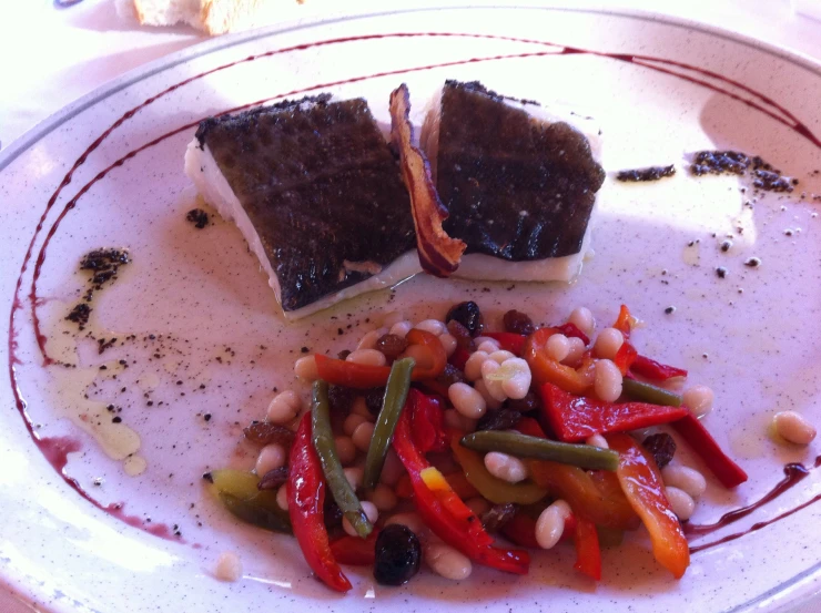 a plate with food that includes beans and a sandwich