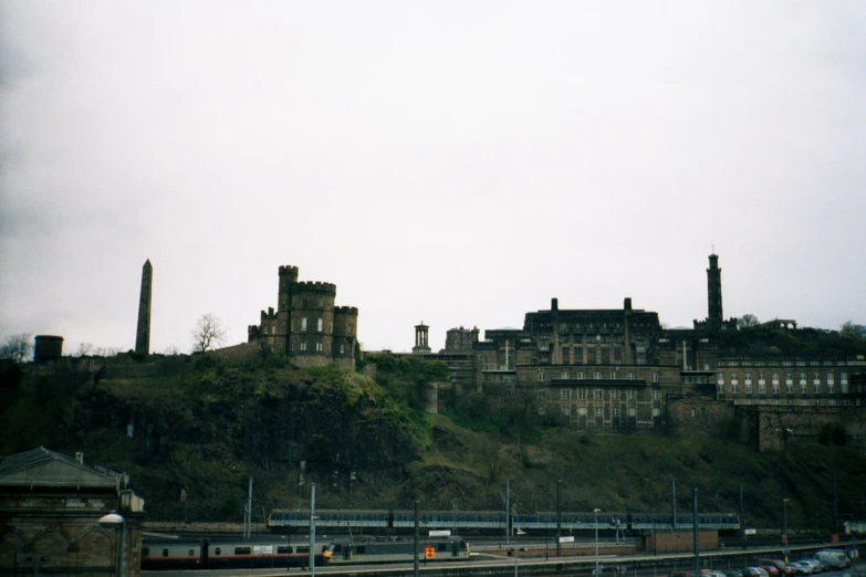 an old, large building that has cars parked by it