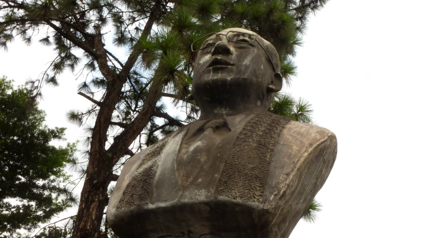 a statue is seen in front of the trees