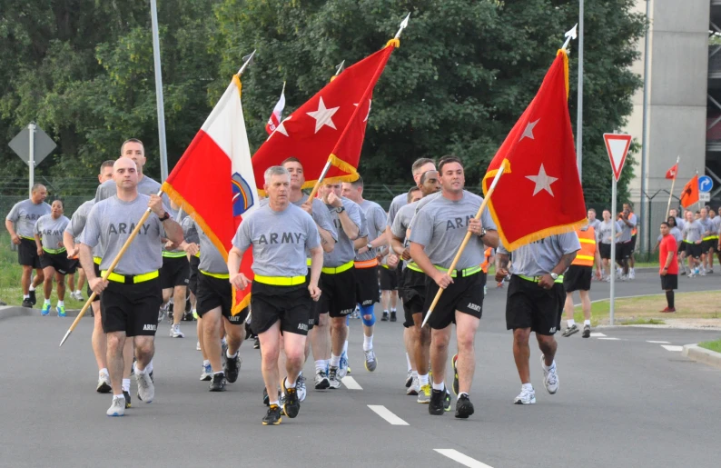 a group of young men that are holding flags