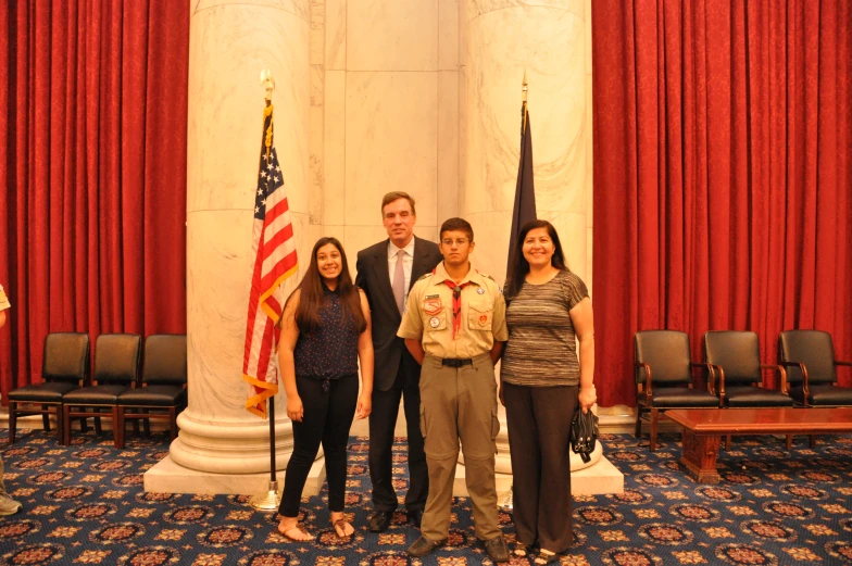 a man and three women standing in a room