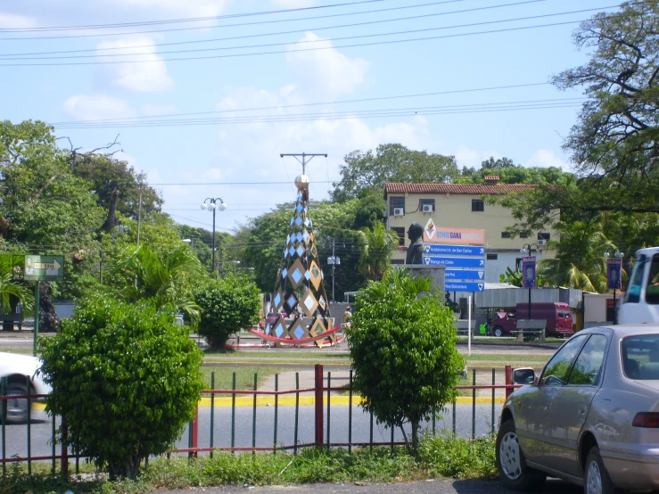 a monument behind the fence with trees lining both sides