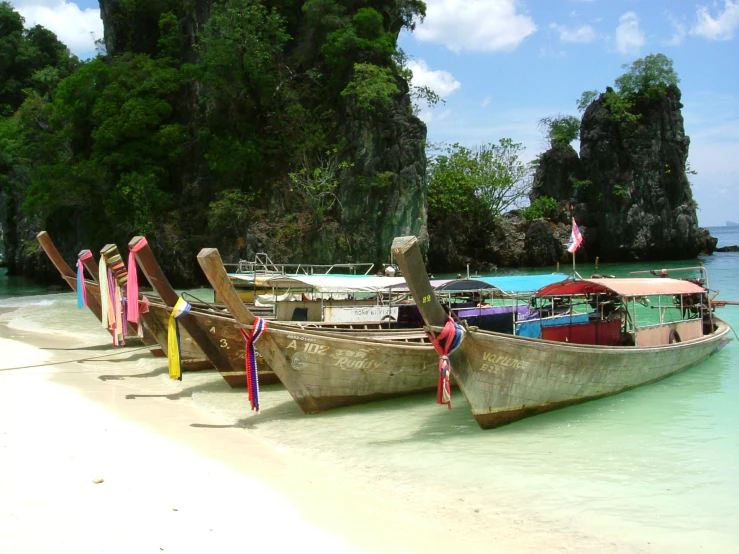 there are several boats tied up on the beach