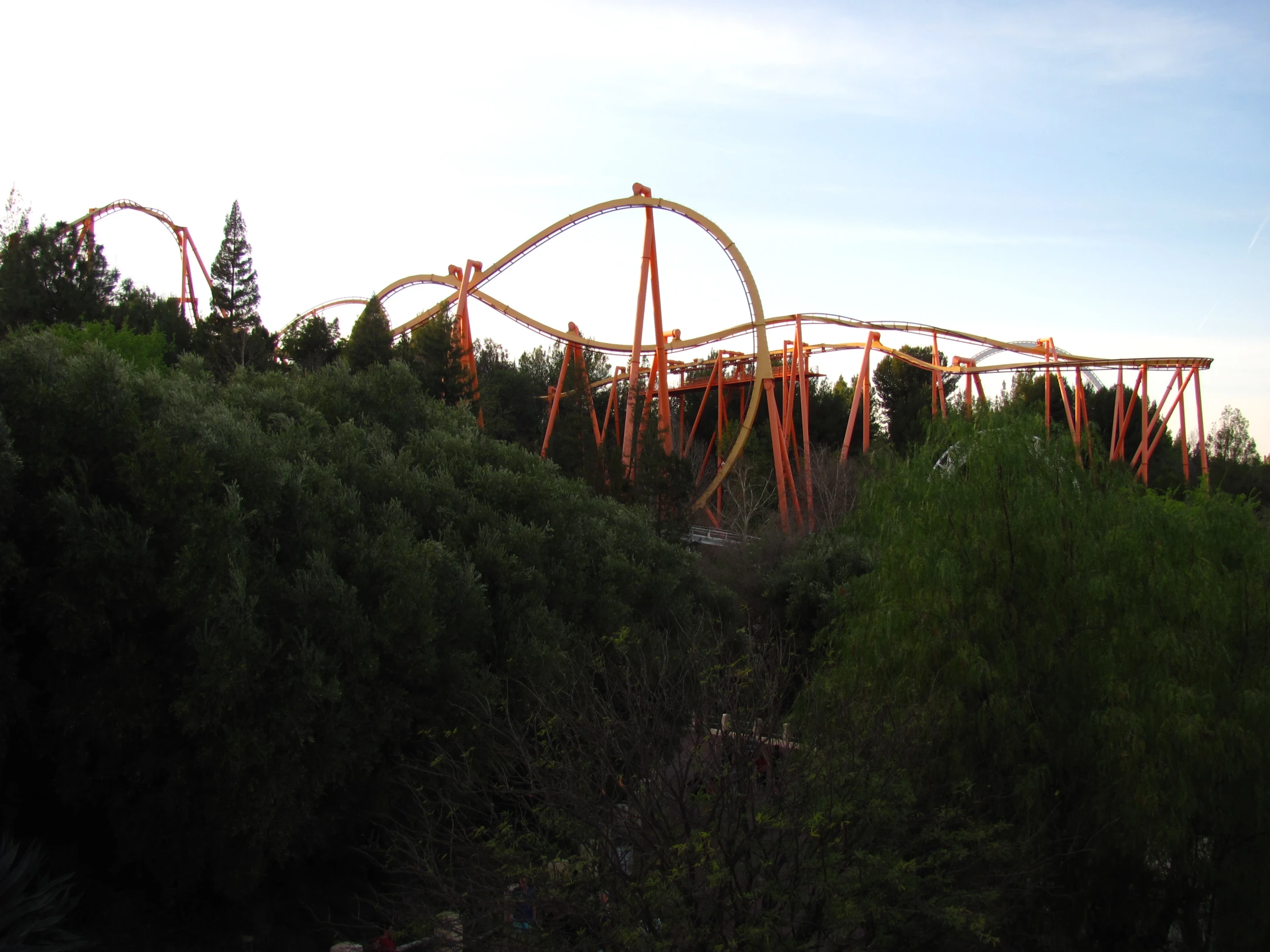 an amut park roller coaster and its orange rides