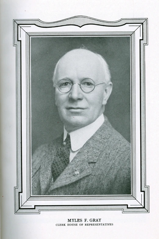 a portrait of a man with glasses wearing a suit