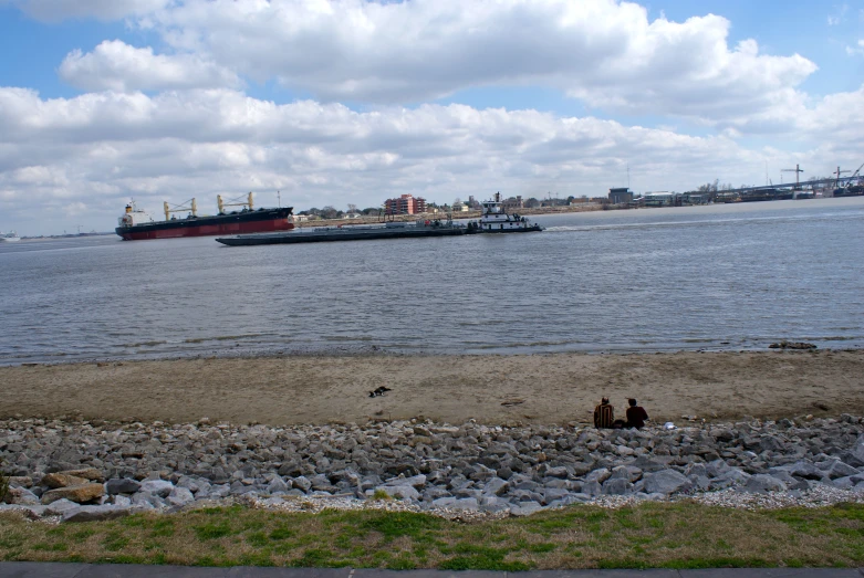 a large ship near some rocks and gravel