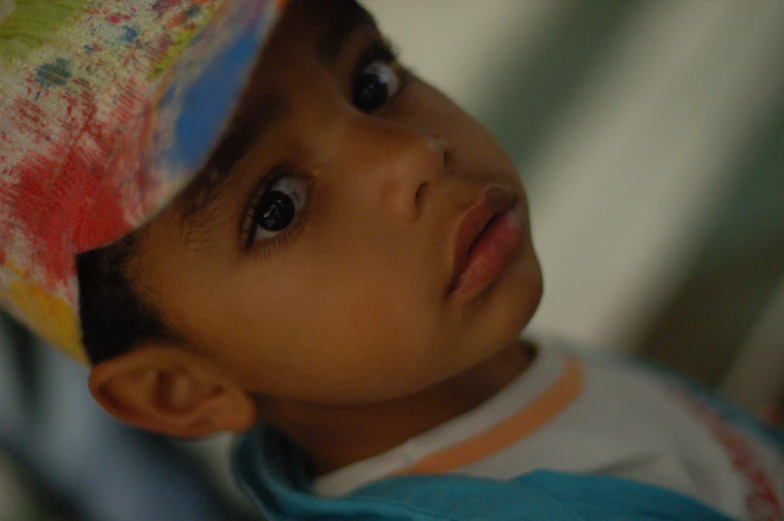 a child wearing a colorful hat in the day