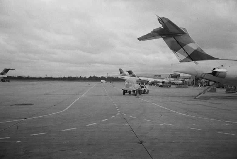 a black and white po of several planes on an airport runway