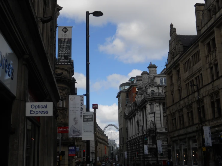 an empty city street has a ferris wheel on it