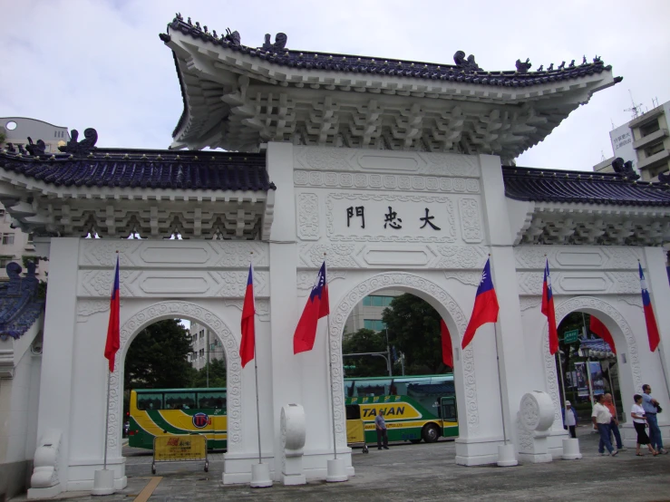 a large white building with many flags hanging on it