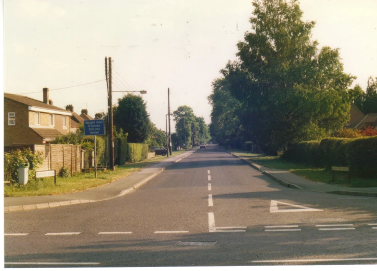 an empty road with a single lane and trees around