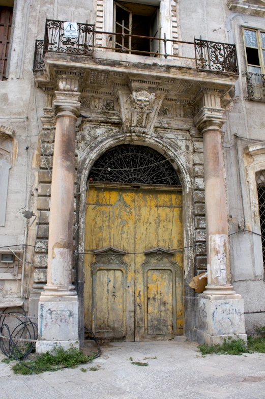 an old building has two double yellow doors