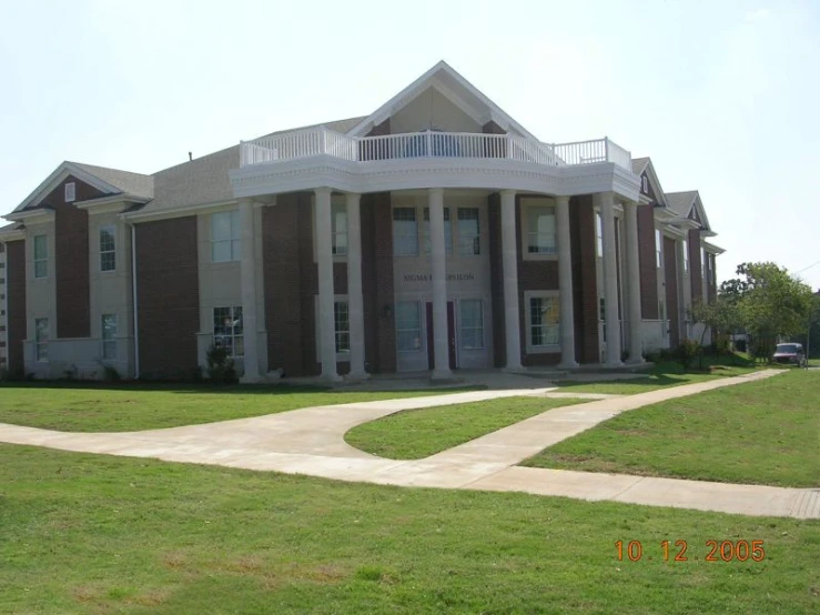 a long building is shown in the middle of a grassy field