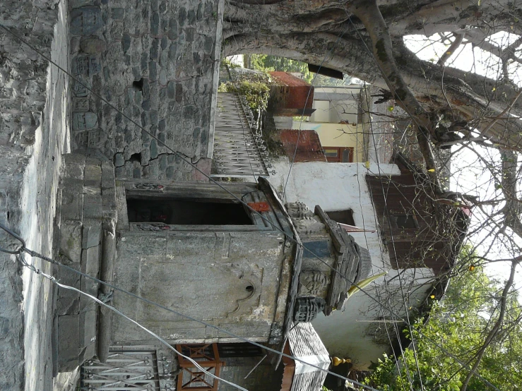 an old building with a tree in the yard