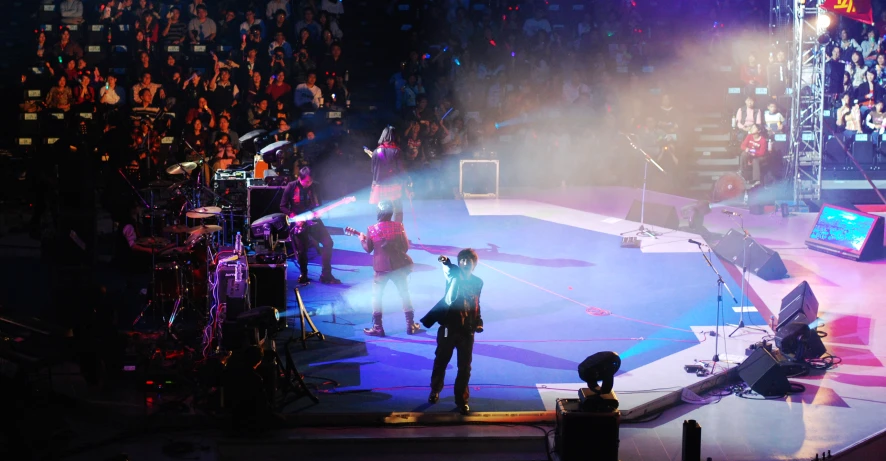 two men on stage in front of an audience