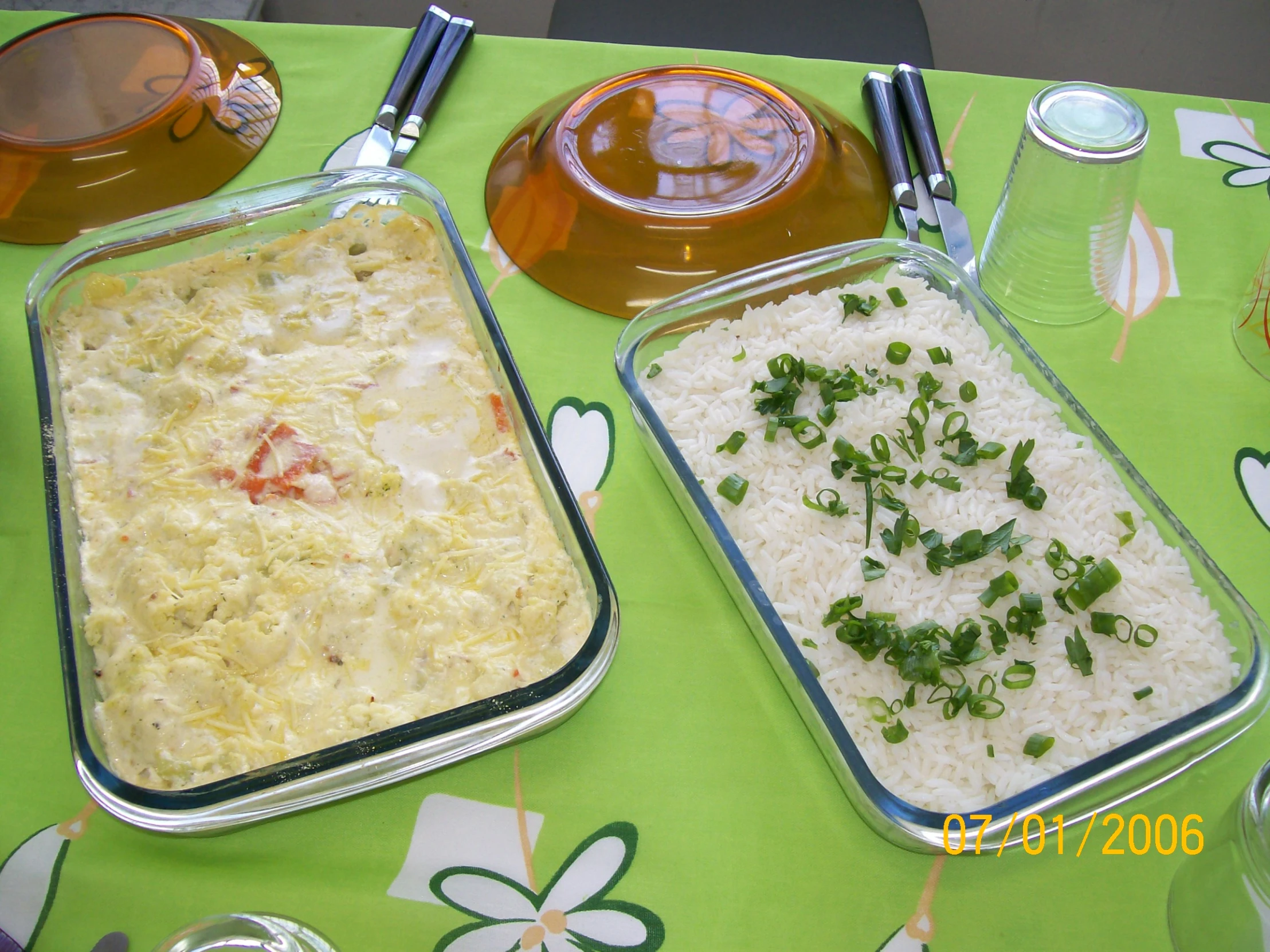 a green table cloth is shown with a couple casseroles and tea pots