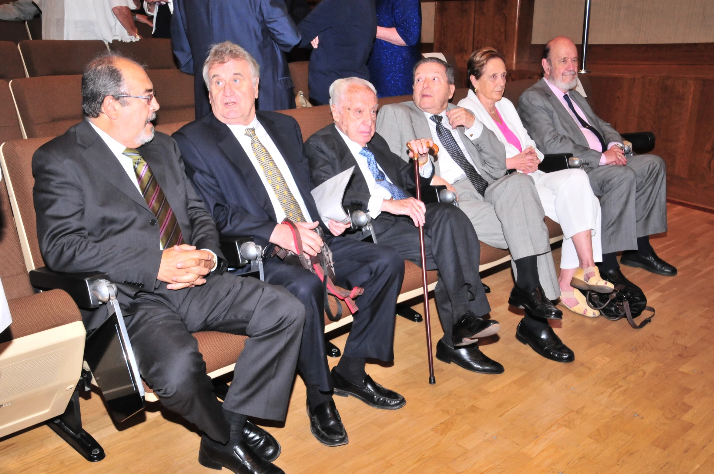 six people sitting in chairs in a large room