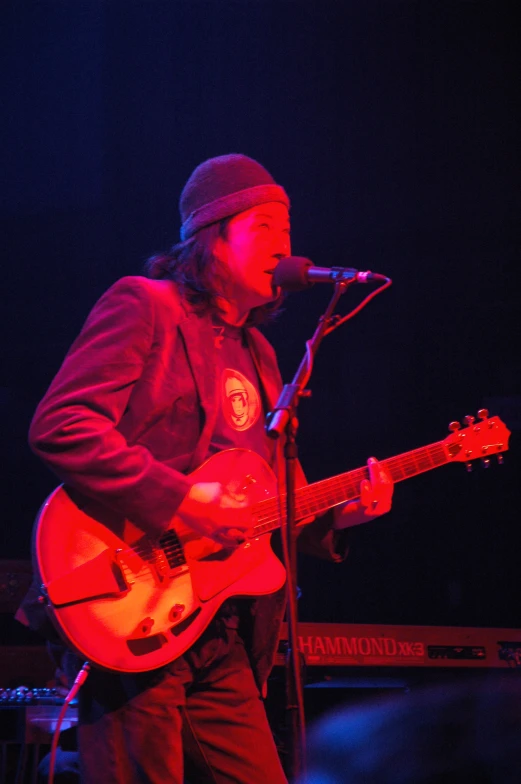 a person on a stage with a guitar